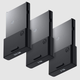 Three Xbox storage expansion cards, 512GB, 1TB and 2TB, floating on a gray, gray background.